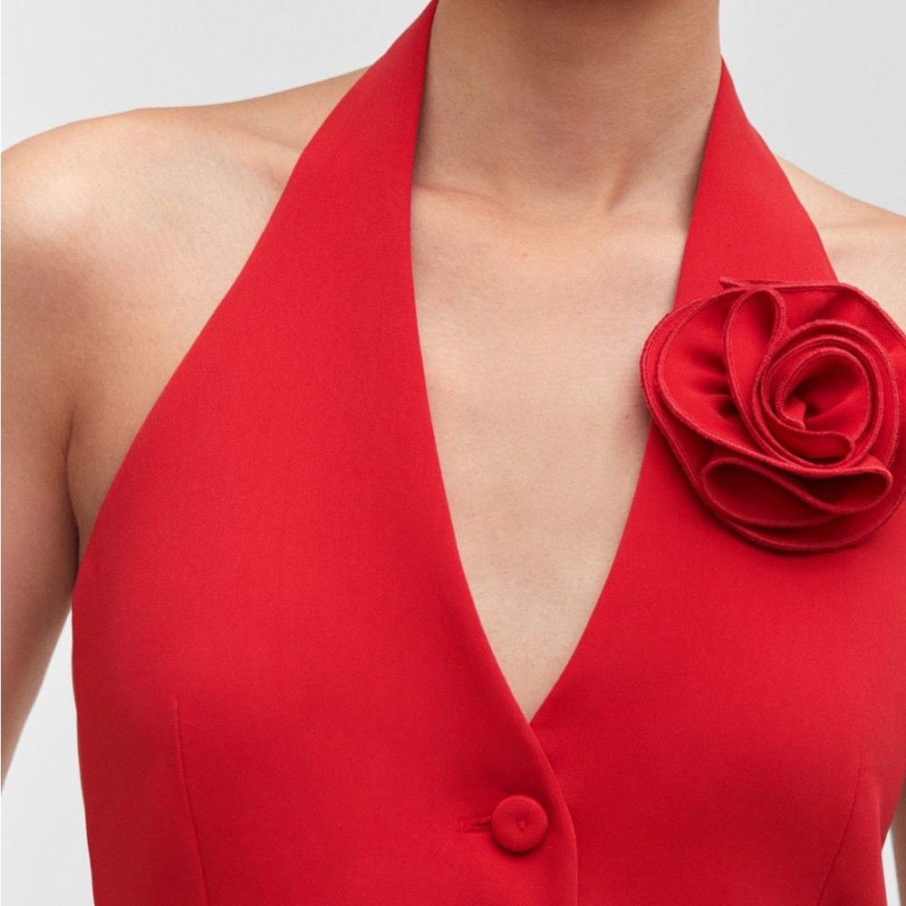 Red vest with floral appliqué